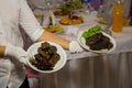 The waitress in white gloves holds two plates with a meat dish. Restaurant catering services Royalty Free Stock Photo