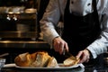 waitstaff member slicing bread at a tableside Royalty Free Stock Photo