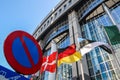 Waiving flags in front of European Parliament building. Brussels, Belgium Royalty Free Stock Photo