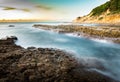 A long exposure shot of a river connecting to the sea during sunset or dusk in Wakamatsu, Kitakyushu, Fukuoka, Japan. Royalty Free Stock Photo