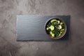 Wakame salad raw seaweed with cucumber slices and sesame in bowl on dark gray background Royalty Free Stock Photo