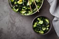 Wakame salad raw seaweed with cucumber slices and sesame in bowl on dark gray background Royalty Free Stock Photo