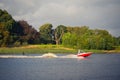 Wake-boarding on a lake behind a boat Royalty Free Stock Photo