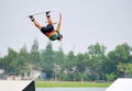 Wake boarding rider flying and somersault trick. Royalty Free Stock Photo