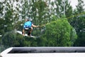 Wake boarding rider jumping and flying trick.