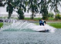 Wake boarding rider jumping trick with water splash. Royalty Free Stock Photo