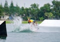 Wake boarding rider jumping trick with water splash. Royalty Free Stock Photo