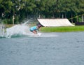 Wake boarding rider jumping trick with water splash.