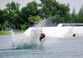 Wake boarding rider jumping trick with water splash. Royalty Free Stock Photo