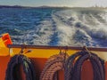 Wake of boat with coiled ropes
