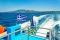 Wake from Greek speed boat and Greece flag Royalty Free Stock Photo