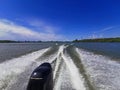 Wake leads water behind speeding boat