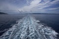 Wake of a ship trail, on sea with cloudy sky