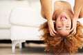 Wake up and be awesome. Shot of a young woman lying upside down on her couch. Royalty Free Stock Photo