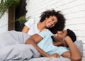 Happy young couple waking up in morning in bed Royalty Free Stock Photo