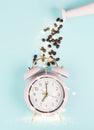 Wake up in the morning, time for breakfast, coffee break, alarm clock with roasted beans and hearts pouring from a can