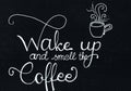 `Wake up and smell the coffee` hand lettering saying in white, chalk writing on a black paper