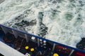 Wake of vessel. Wide wake trail from boat. Ocean water. Deep blue. Trace from large ship. Sunset rays on water from Royalty Free Stock Photo