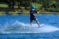 Wakeboard training with water splash and professional wakeboarder at a cable wakeboard park Royalty Free Stock Photo