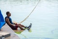 Wakeboarder with focused face relaxes after training Royalty Free Stock Photo