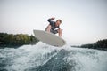 Wakeboarder jumping on the blue wave against the background of c Royalty Free Stock Photo