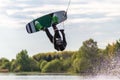 Wakeboarder making tricks. Low angle shot of man wakeboarding on a lake. Royalty Free Stock Photo