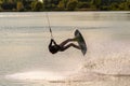 Wakeboarder making tricks. Low angle shot of man wakeboarding on a lake. Royalty Free Stock Photo