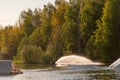 Wakeboarder making tricks. Low angle shot of man wakeboarding on a lake. Royalty Free Stock Photo