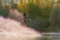 Wakeboarder making tricks. Low angle shot of man wakeboarding on a lake. Royalty Free Stock Photo