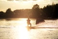 Wakeboarder making tricks. Low angle shot of man wakeboarding on a lake. Royalty Free Stock Photo