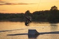 Wakeboarder making tricks. Low angle shot of man wakeboarding on a lake. Royalty Free Stock Photo