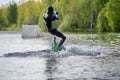 Wakeboarder making tricks. Low angle shot of man wakeboarding on a lake. Royalty Free Stock Photo