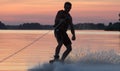 Wakeboarder making tricks on sunset