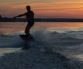 Wakeboarder making tricks on sunset