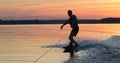 Wakeboarder making tricks on sunset Royalty Free Stock Photo
