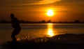 Wakeboarder making tricks on sunset Royalty Free Stock Photo