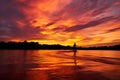 wakeboarder performing a trick at sunset, silhouette against colorful sky