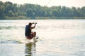 Wakeboarder rides among splashes. Back view. Royalty Free Stock Photo