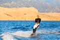 Wakeboarder in sunset.