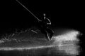 Wakeboarding. Athlete silhouette with splash of water during sunset Royalty Free Stock Photo