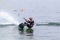 Wakeboarding with a guide mechanism. An unknown athlete holds on to the cable, performing tricks in the direction of travel