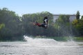 While wakeboarding man jumping over the waves