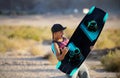 Wake boarding sportsman jumping high trick with big water splash in the cable park, active water sports Royalty Free Stock Photo