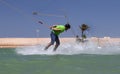 Wakeboarding sportsman jumping high in the cable park, water sports