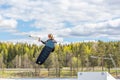 Wakeboarding. Teen Wakeboarder makes extreme Jump in air on wakeboard. Girl flies in the sky Royalty Free Stock Photo