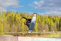 Wakeboarding. Teen Wakeboarder makes extremely difficult jump in air on wakeboard. Girl flies in the sky Royalty Free Stock Photo