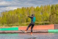 Wakeboarding. Teen Wakeboarder makes extremely difficult jump in air on wakeboard. Girl flies in the sky Royalty Free Stock Photo