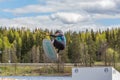 Wakeboarding. Teen Wakeboarder makes extremely difficult jump in air on wakeboard. Girl flies in the sky Royalty Free Stock Photo