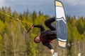 Wakeboarding. Teen Wakeboarder makes extremely difficult jump in air on wakeboard. Girl hanging in the air upside down Royalty Free Stock Photo