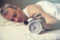 Waked Up. Hand turns off the alarm clock waking up at morning . Royalty Free Stock Photo